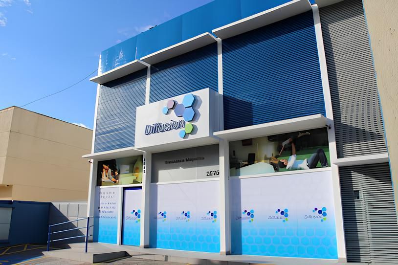 Um grande edifício azul e branco com um céu azul ao fundo.