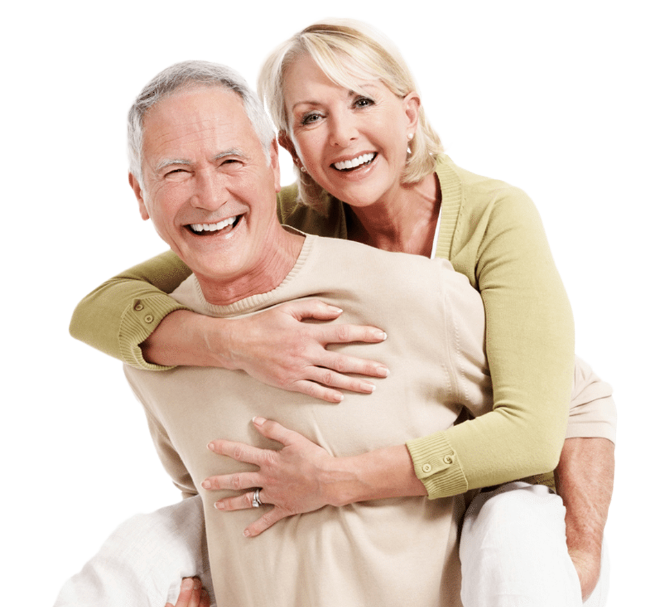 A woman is carrying a man on her back and they are smiling.