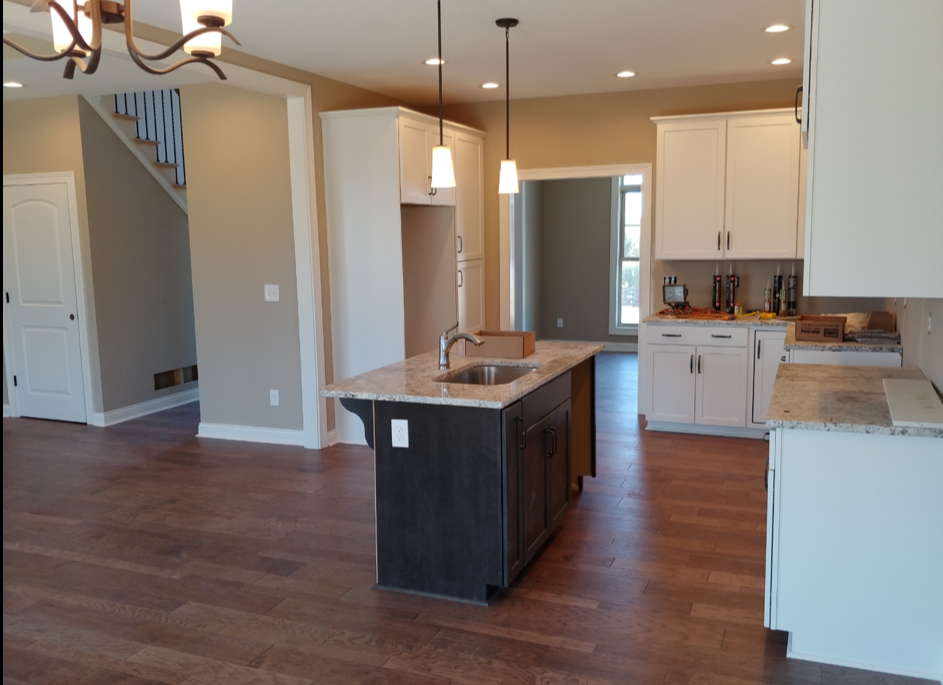 A living room with a couch , chairs , a table and a television.