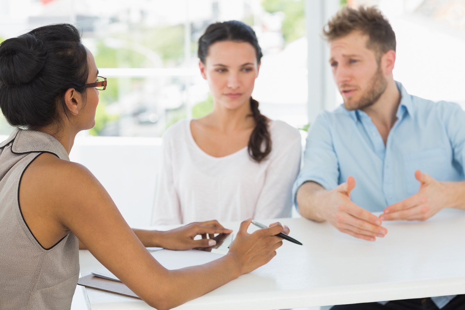 a couple talking to a woman