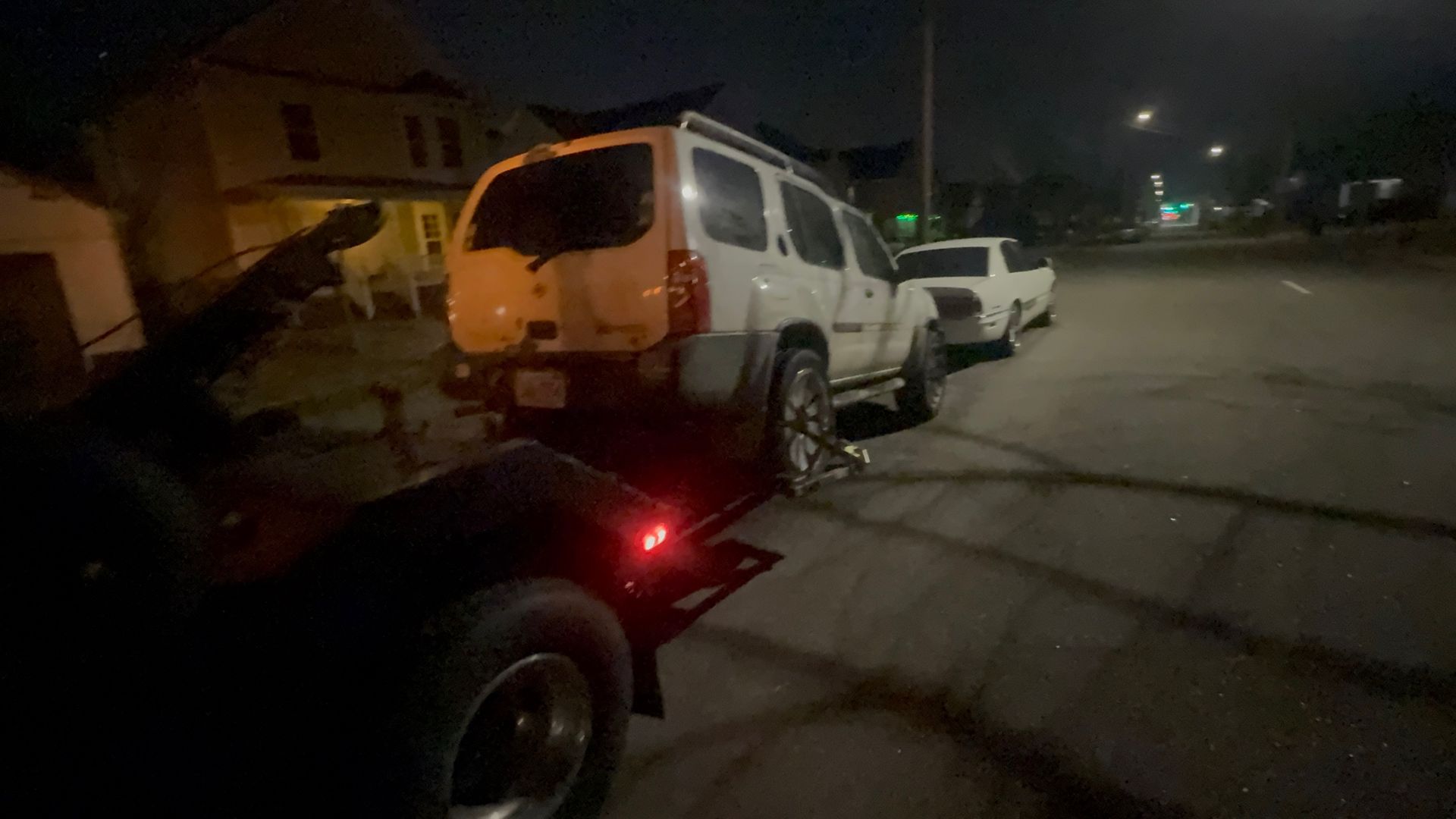 Family gathered at a dining table in a kitchen. They are eating and talking together.