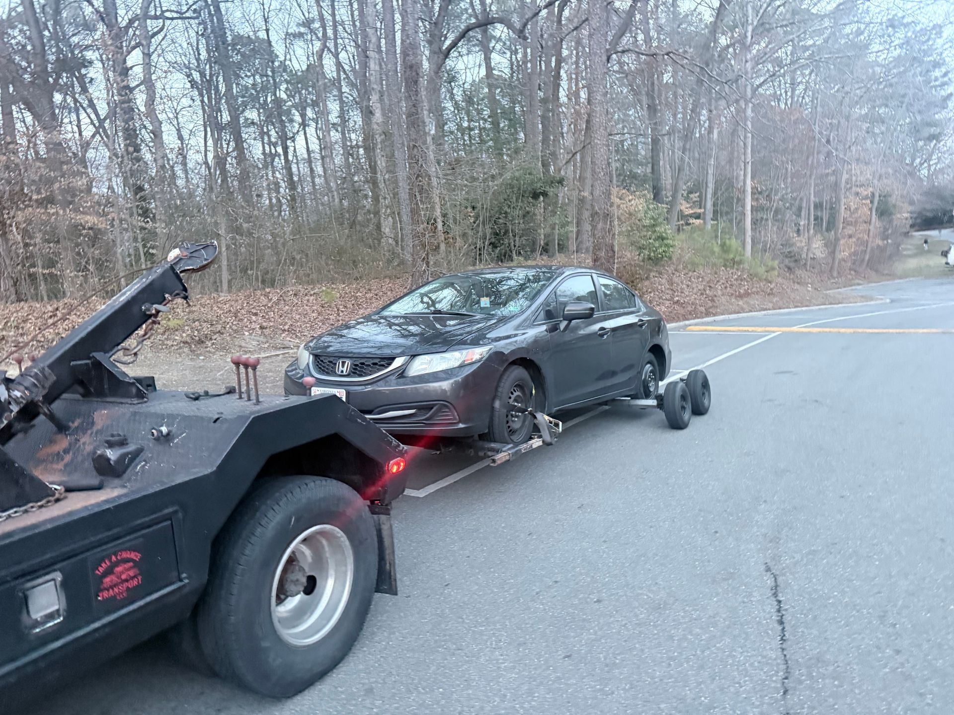 A person holding a baby up in the air indoors near a window, baby smiling.
