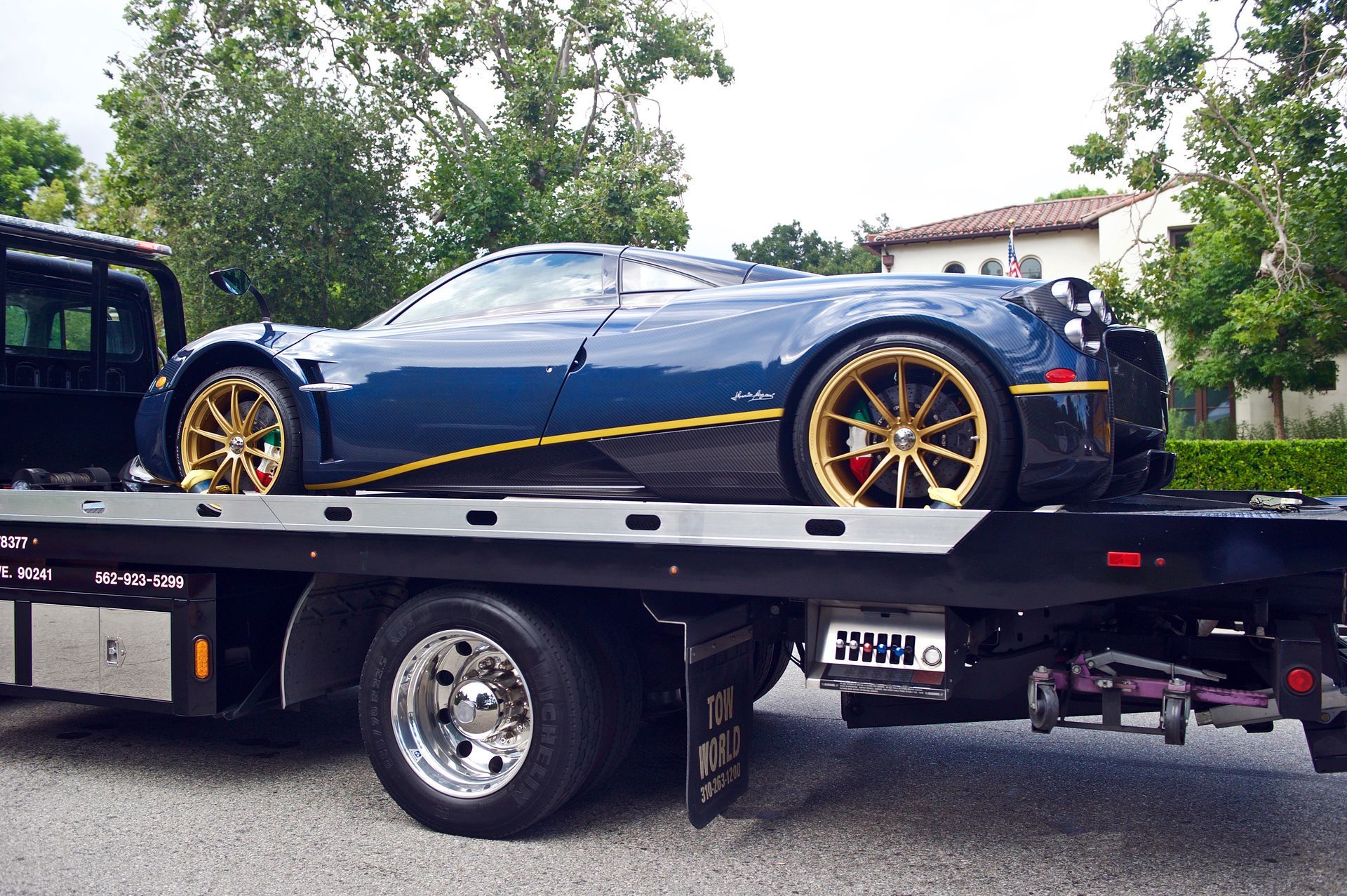 A person holding a baby up in the air indoors near a window, baby smiling.