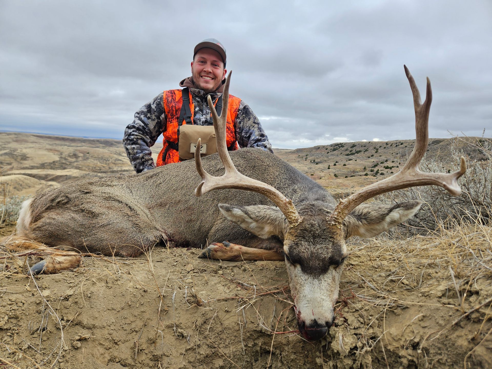 A man smiling with a dead deer