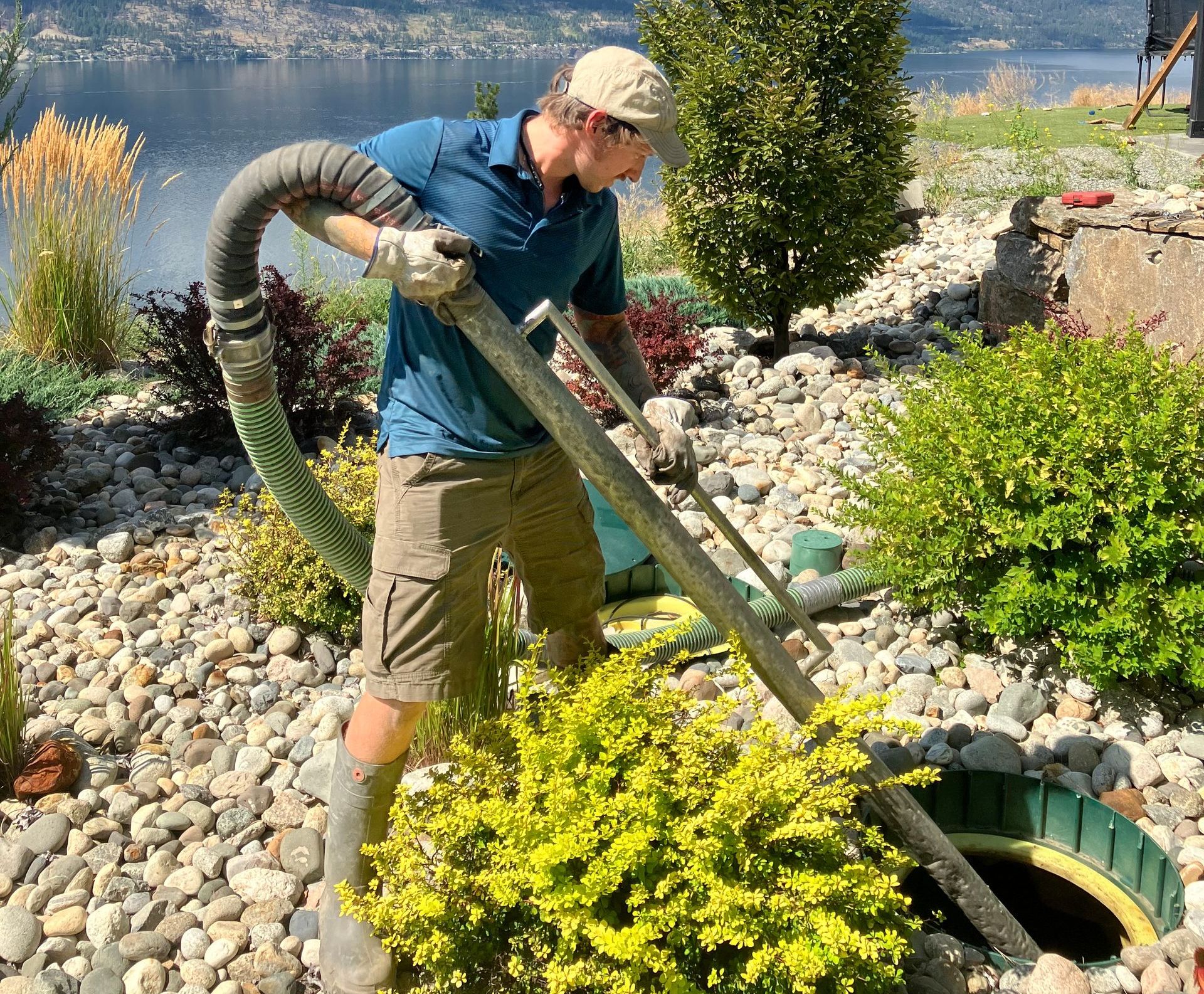 A man is pumping water into a septic tank.