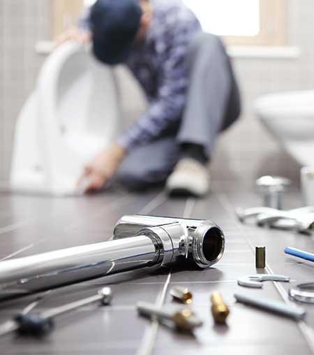 Plumber working in bathroom — Plumbing Renovations in Armidale, NSW