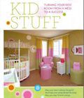 A picture of a child 's room with a crib , chair , nightstand , and table.