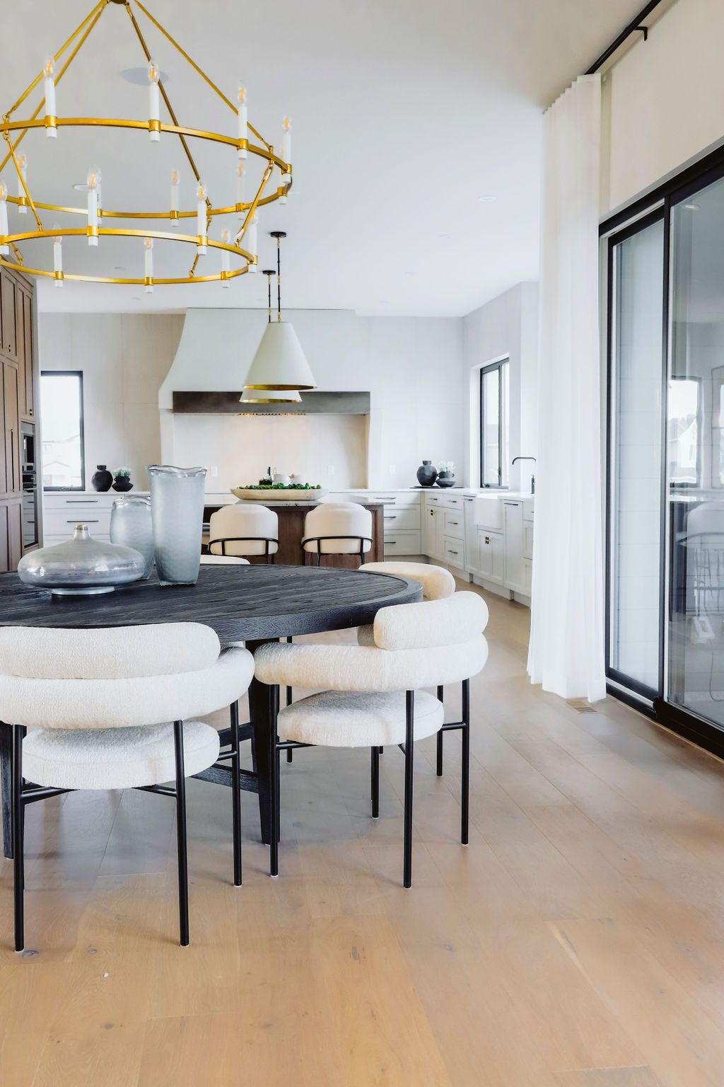 A dining room with a table and chairs and a chandelier.