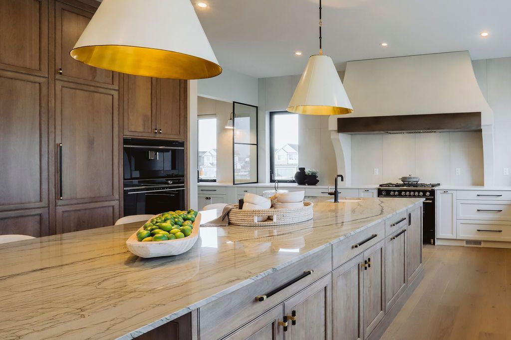A kitchen with a large island and a bowl of lemons on the counter.