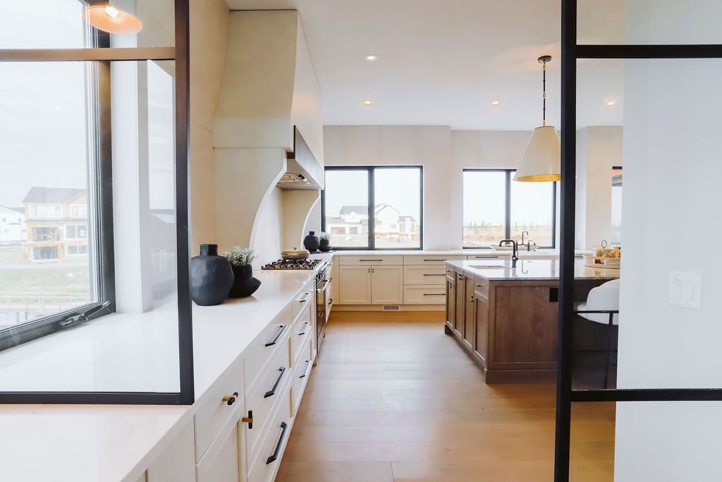 A kitchen with a sliding glass door between the kitchen and the living room.