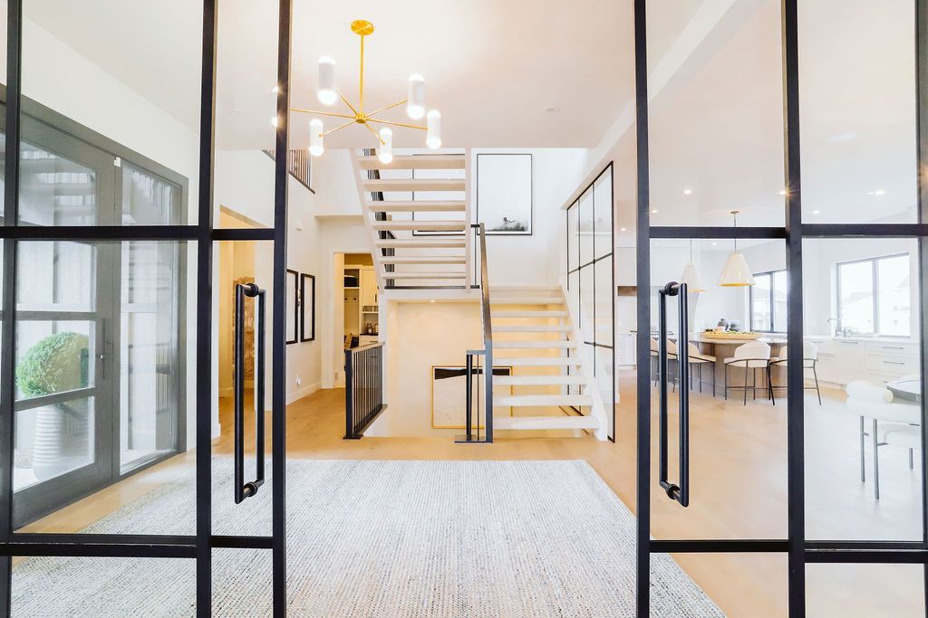 A sliding glass door leading to a staircase in a house.