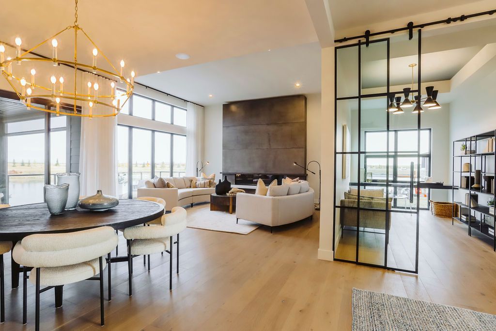 A large living room with a dining table and chairs and a sliding glass door.