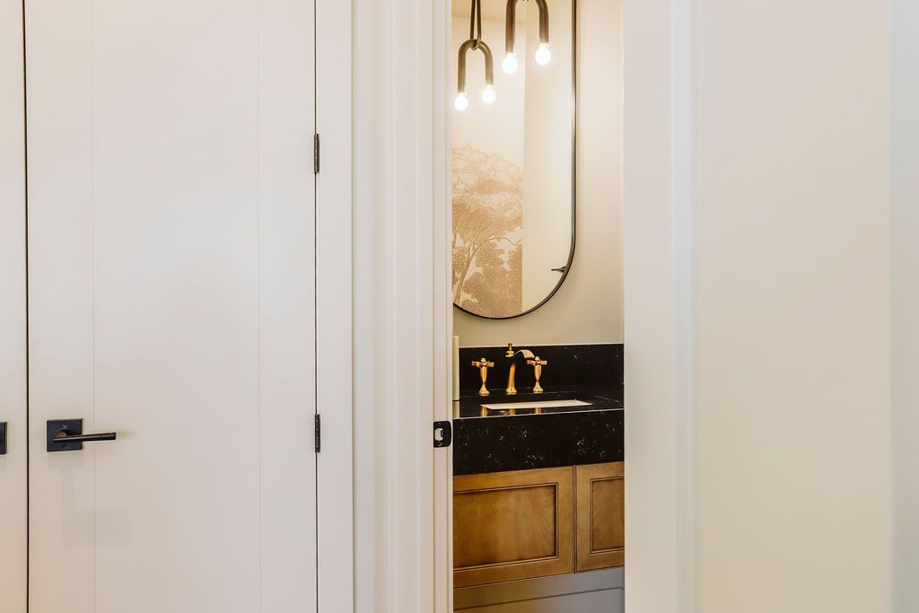 A bathroom with a sink , mirror , and cabinets.