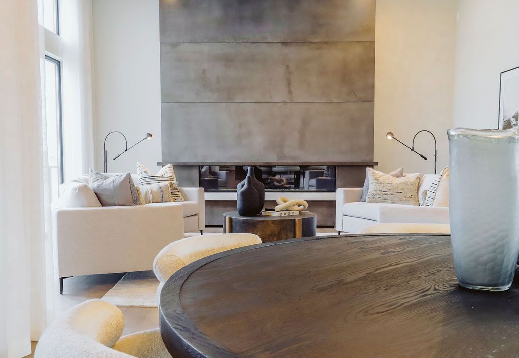 A living room with a table and chairs and a fireplace.