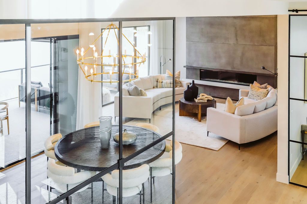 A living room and dining room in a house with sliding glass doors.