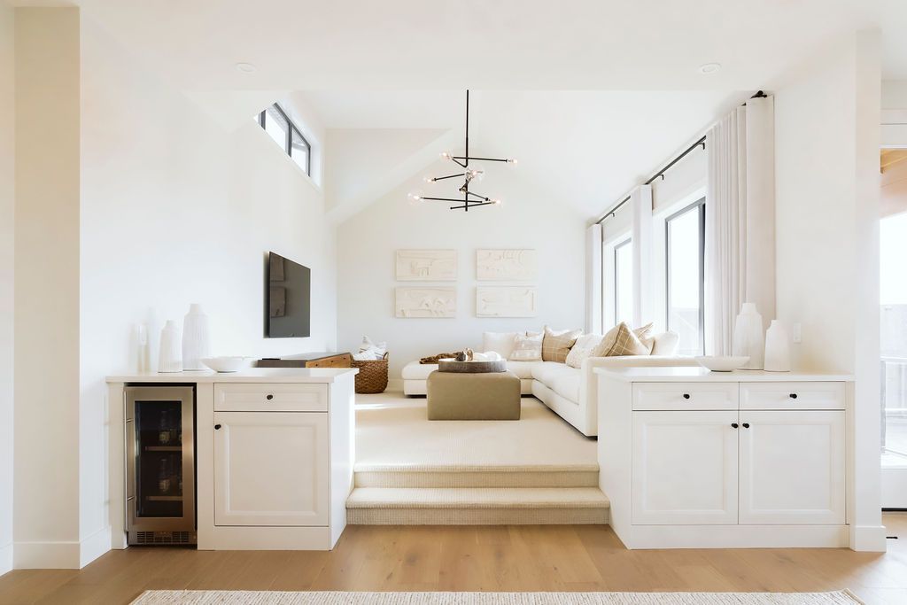 A living room with a large sectional couch and a flat screen tv.