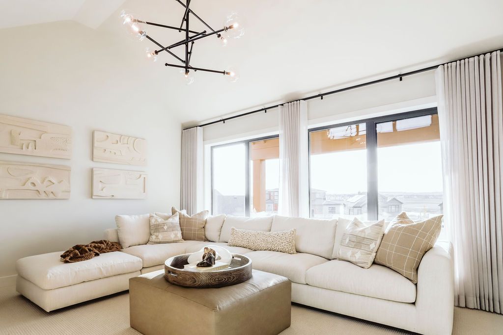 A living room with a large sectional couch and a coffee table.