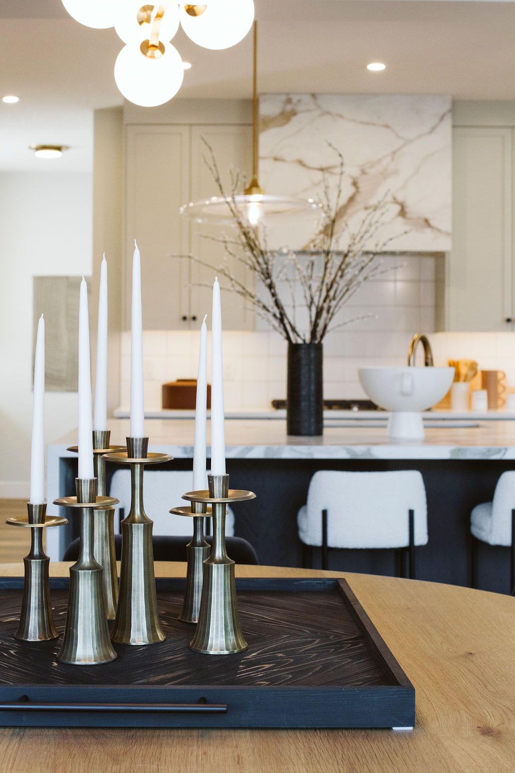 A tray of candles sits on a table in a kitchen