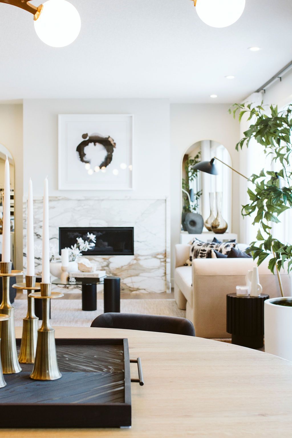 A living room with a fireplace and a table with candles on it