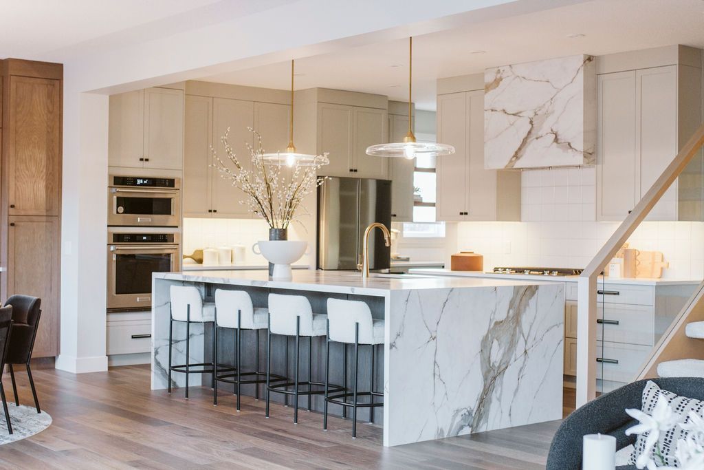 A kitchen with a large island and stools