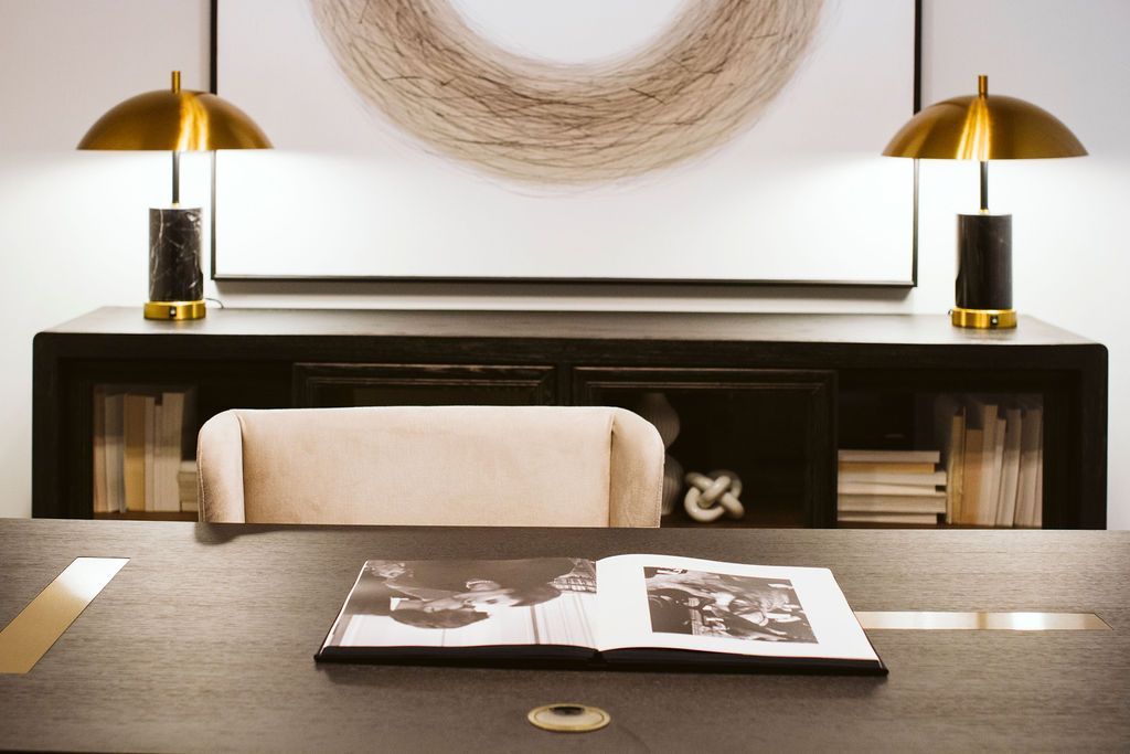 A desk with two lamps and a book on it