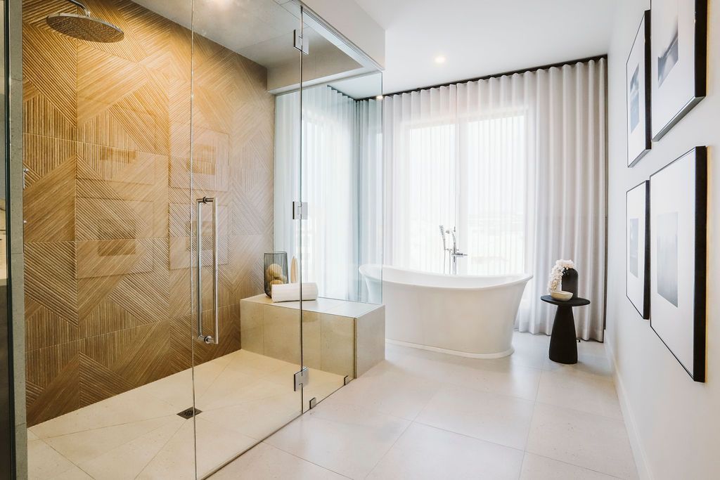 A bathroom with a tub , shower , and walk in shower.