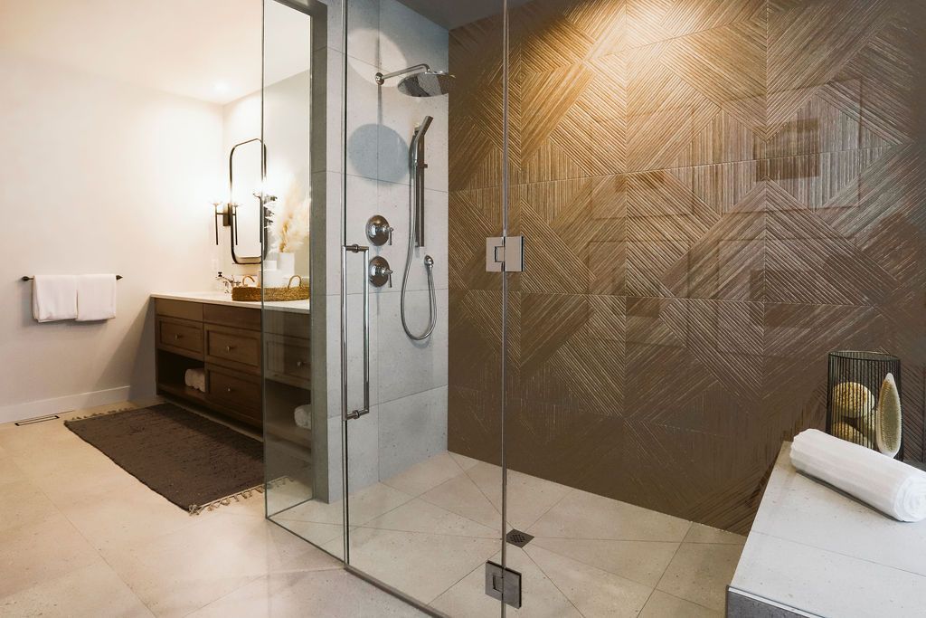 A bathroom with a walk in shower and a sink.