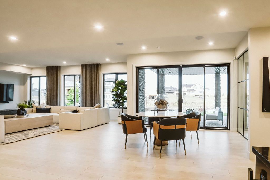 A large living room with a lot of windows and furniture.