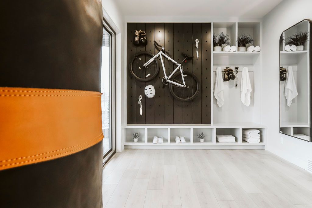 A bicycle is hanging on a wall in a gym.