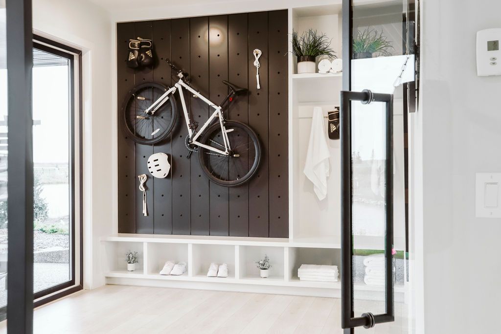A bicycle is hanging on a wall in a room.