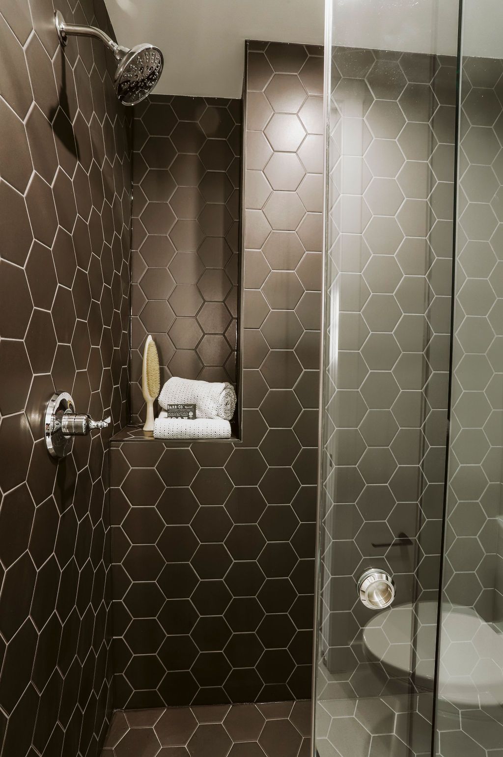 A bathroom with a walk in shower and a toilet.