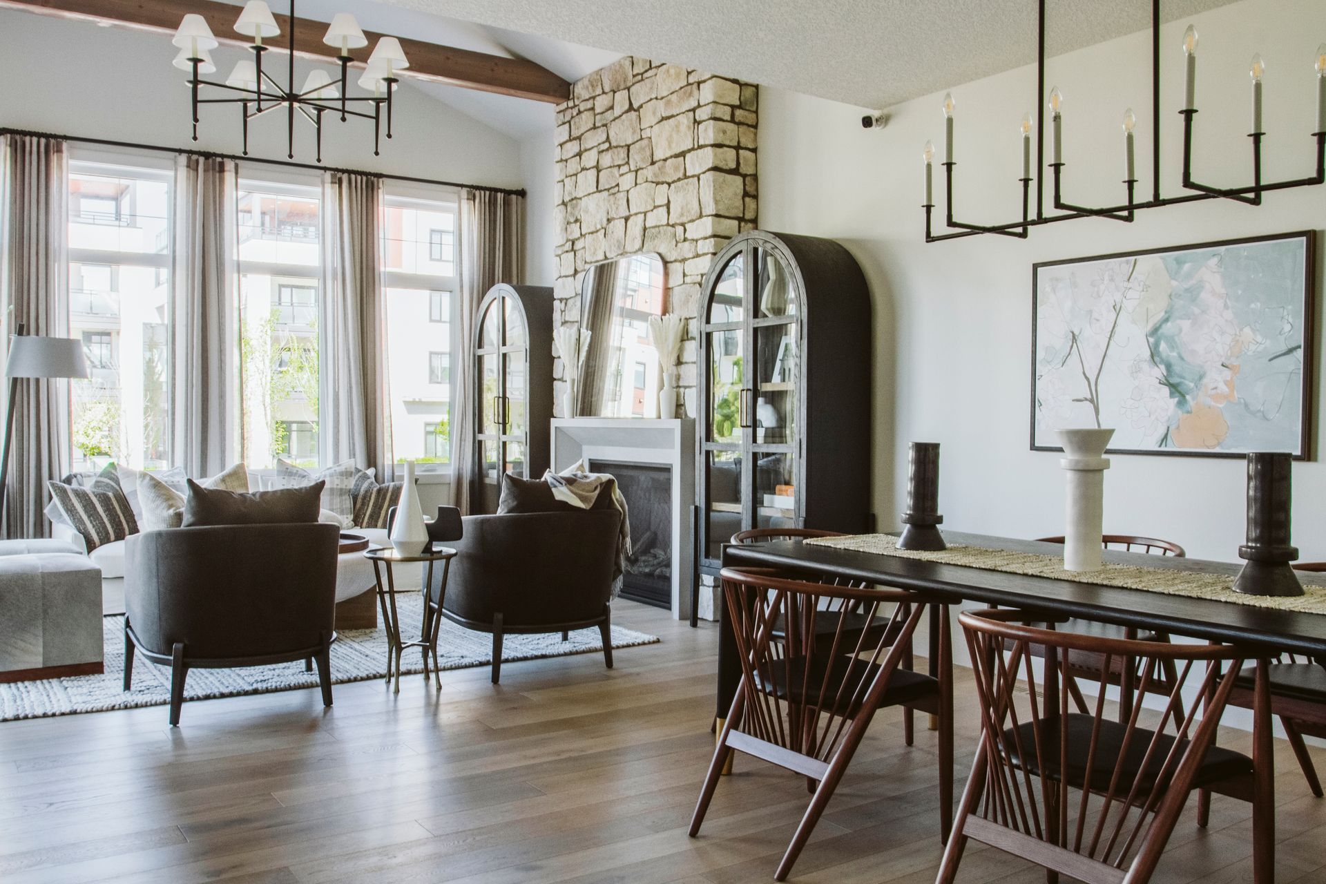 A living room with a dining table and chairs and a fireplace.