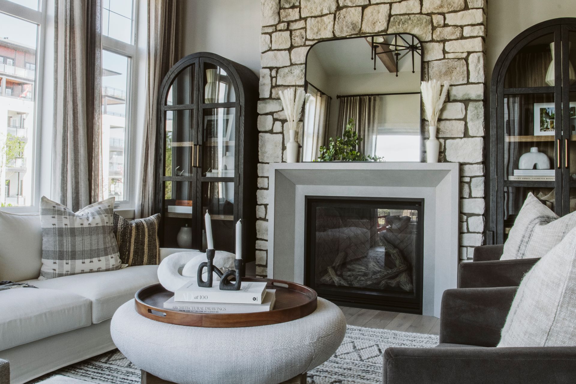 There is a fireplace in the middle of the living room.