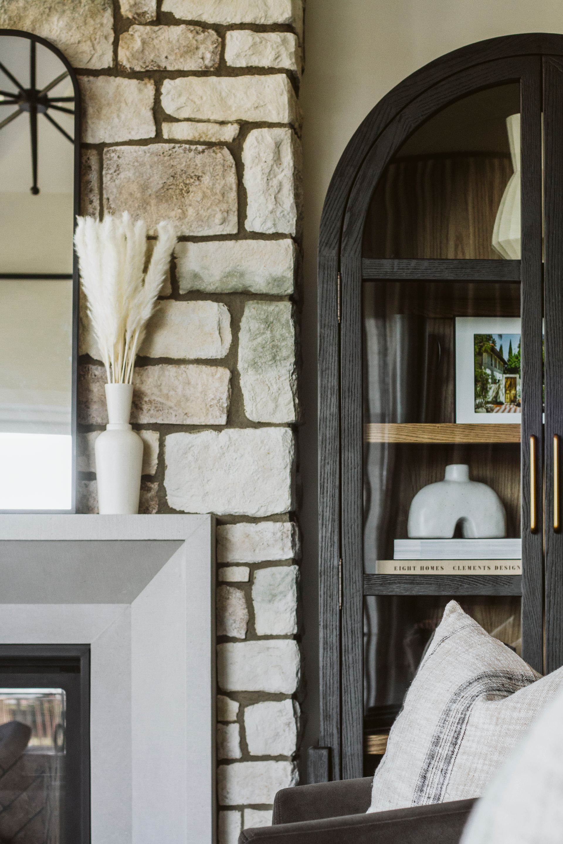A living room with a fireplace and a bookshelf