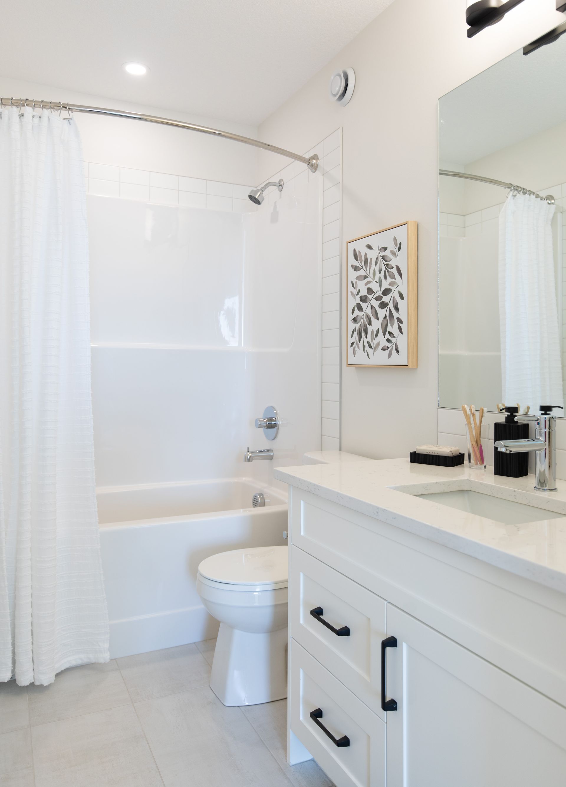 A bathroom with a toilet , sink , tub and shower.