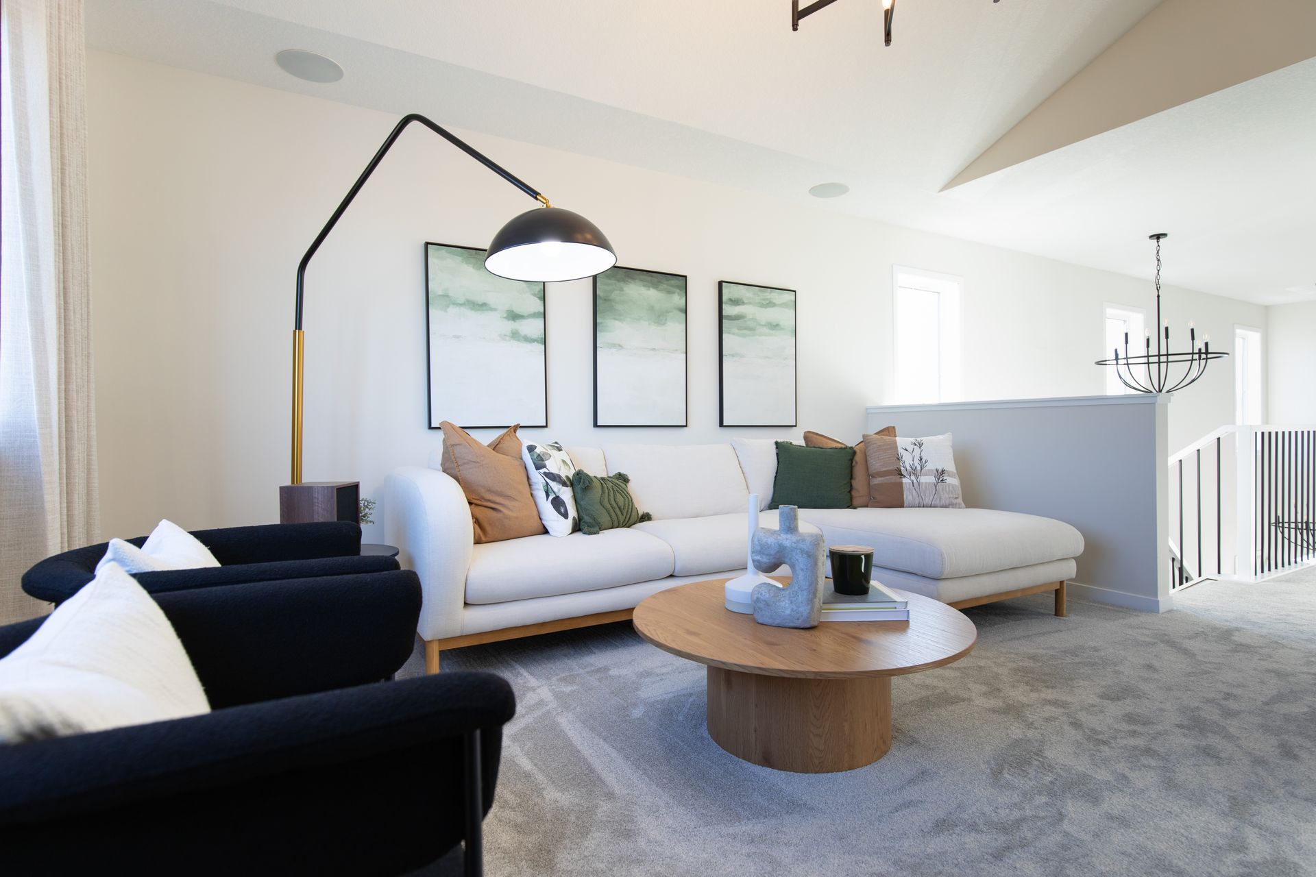 A living room with a couch , chairs , and a coffee table.