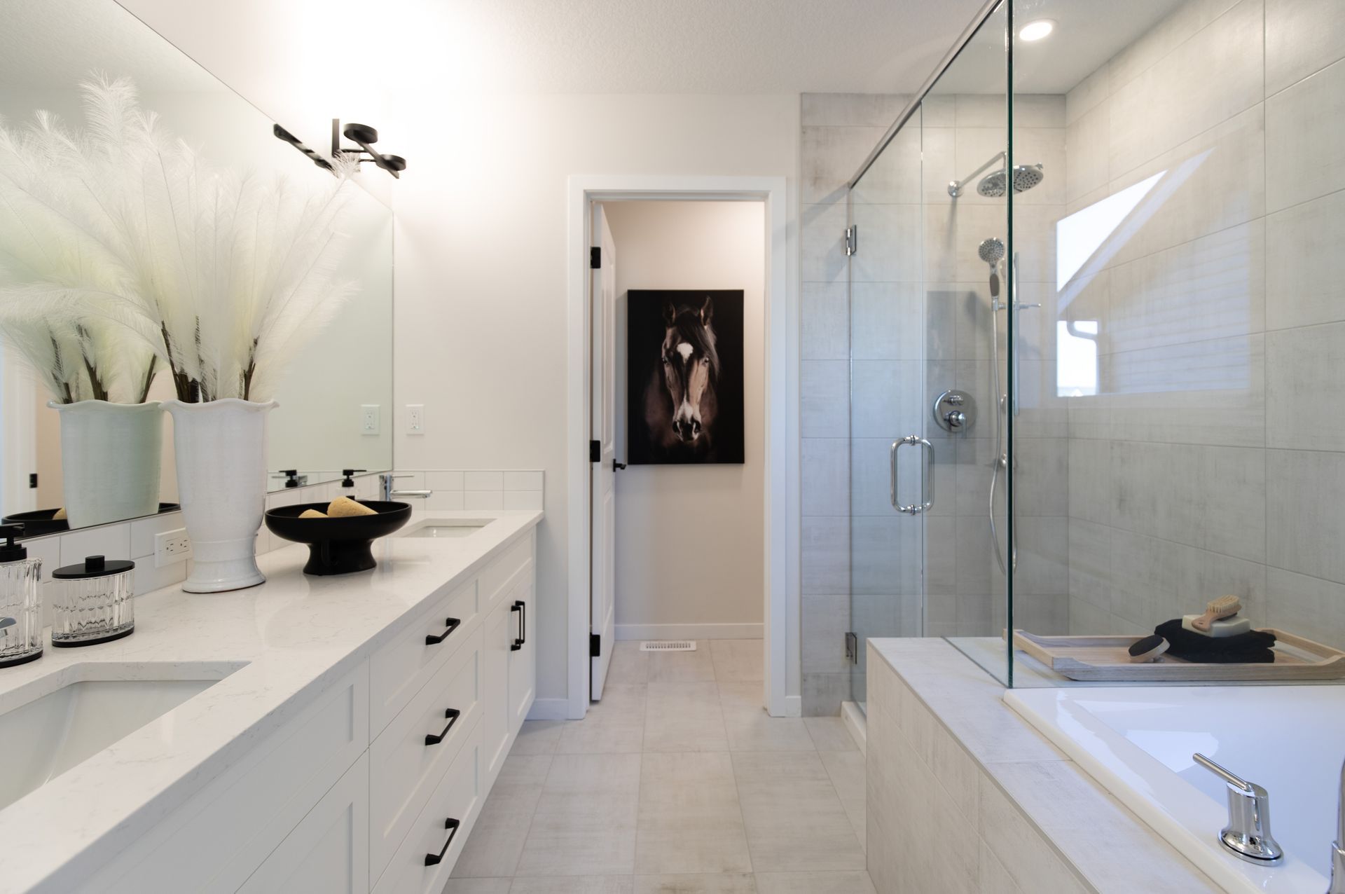 A bathroom with two sinks and a walk in shower