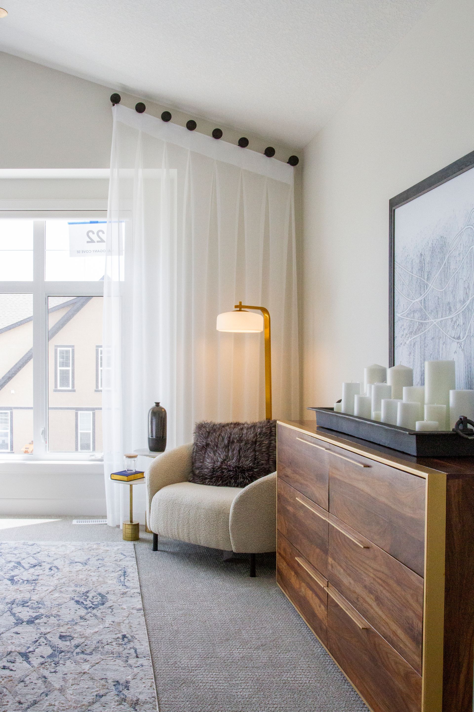 There is a chair and a dresser in the room.