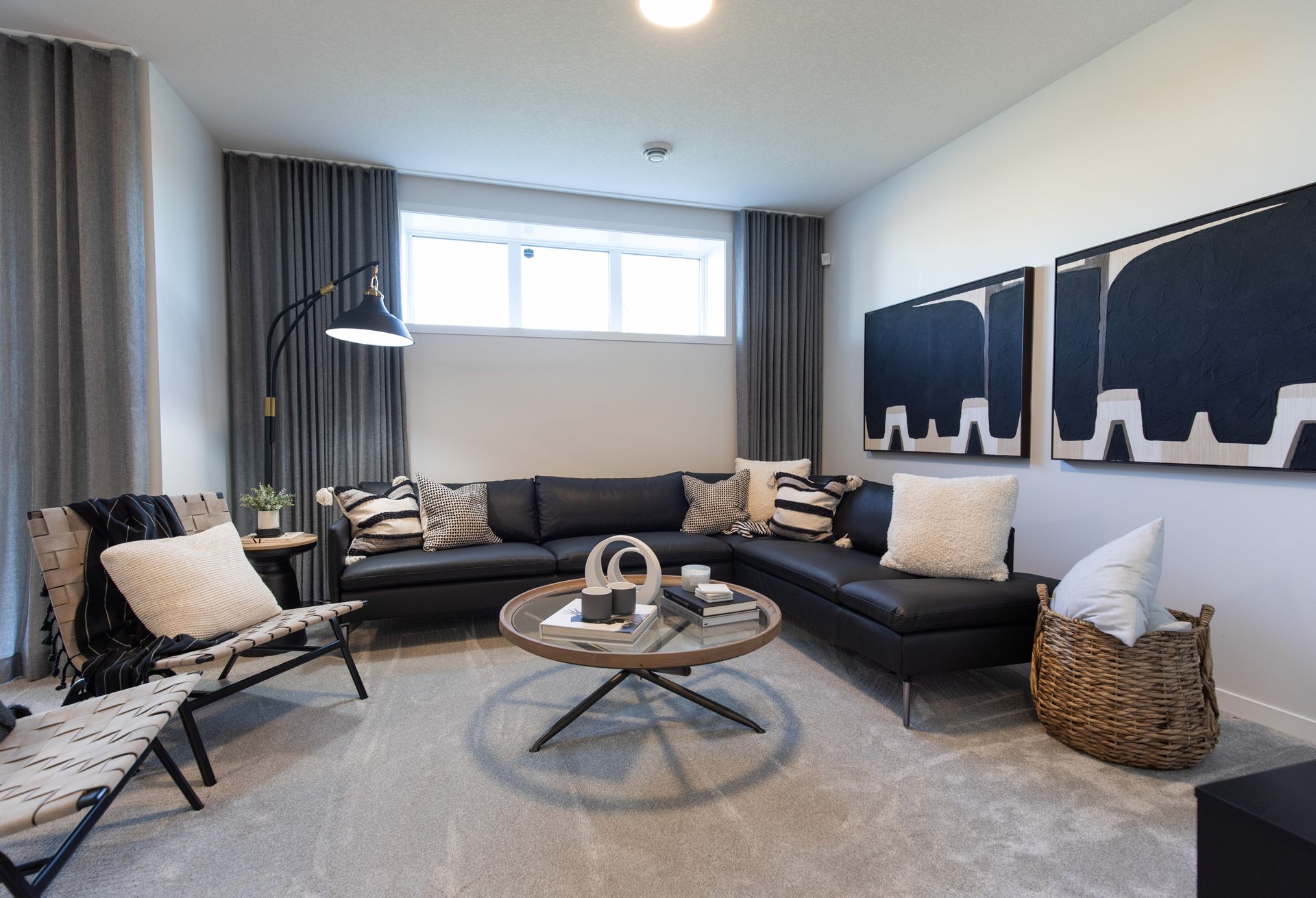 A living room with a couch , chairs , and a coffee table.
