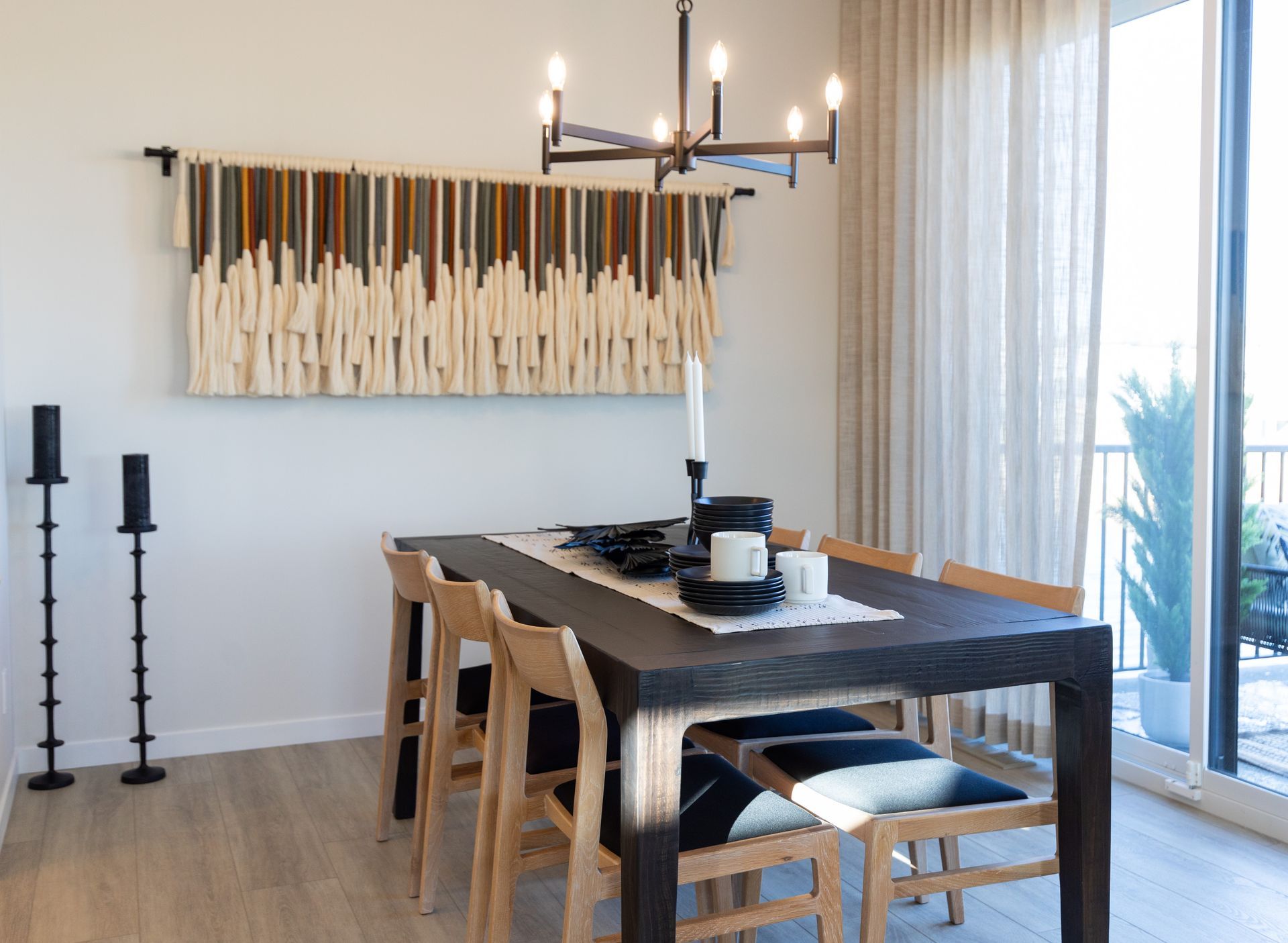 A dining room with a table and chairs and a chandelier.