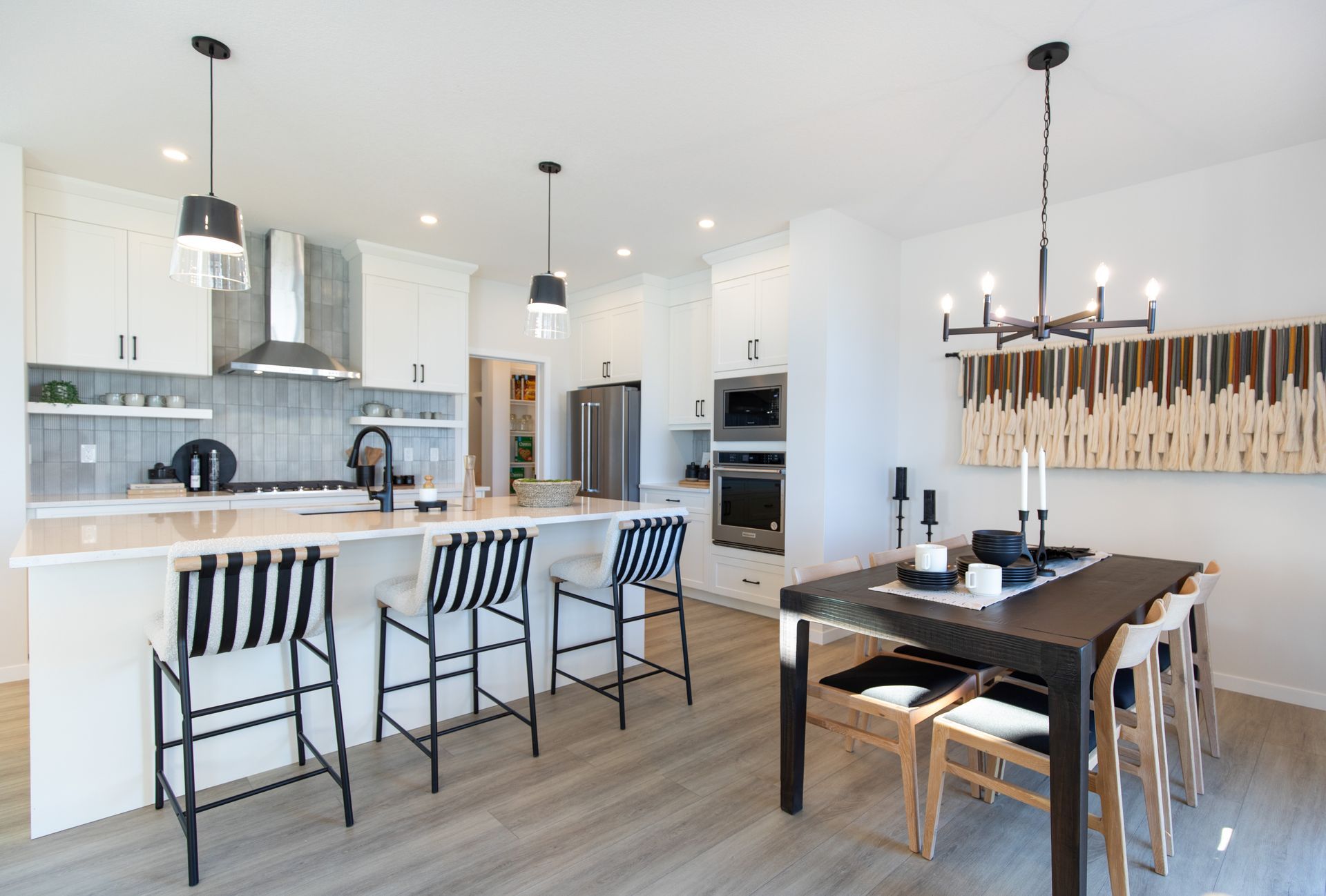 A kitchen and dining room in a house with a table and chairs.