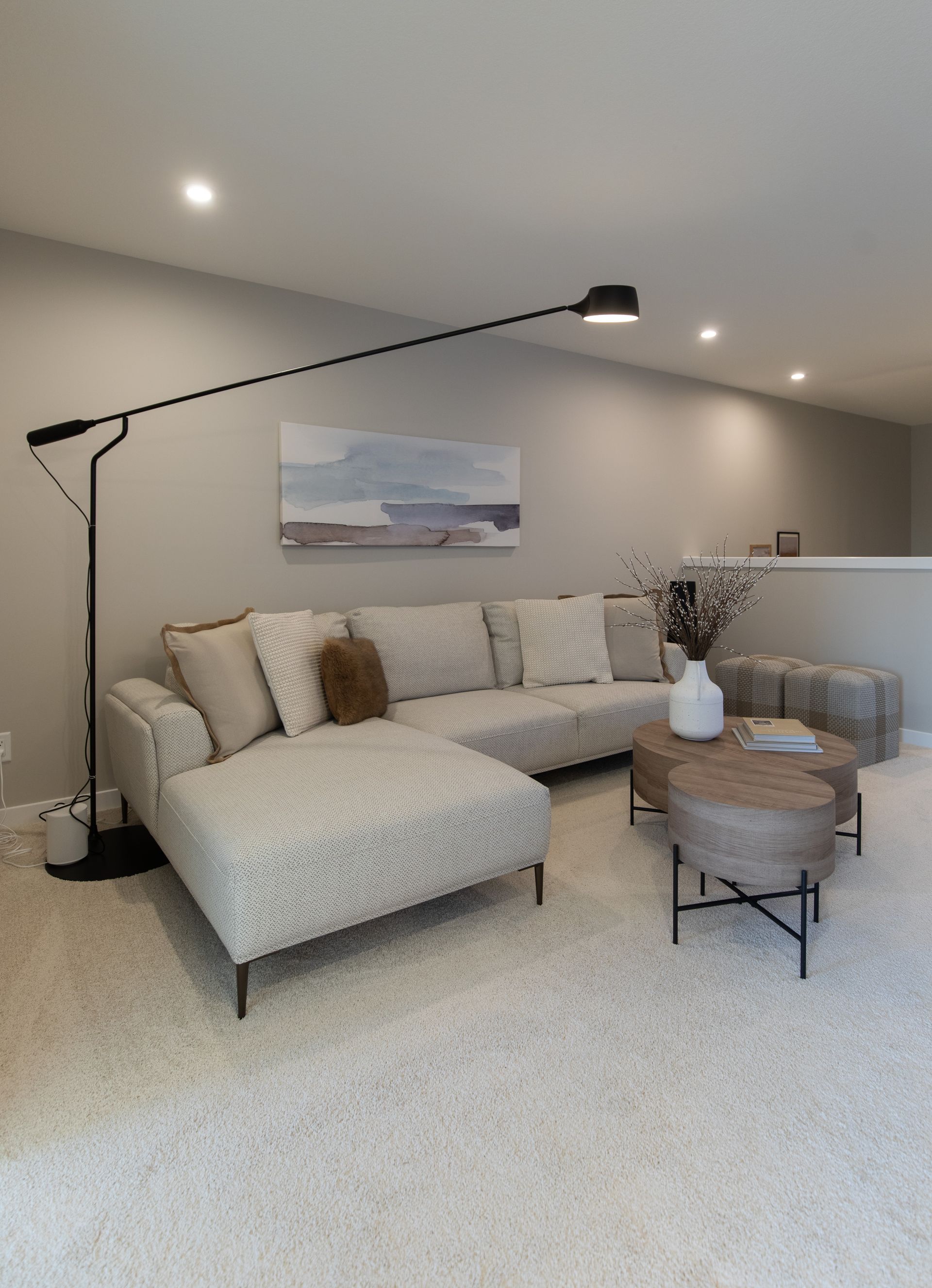 A living room with a couch , coffee table , and lamp.