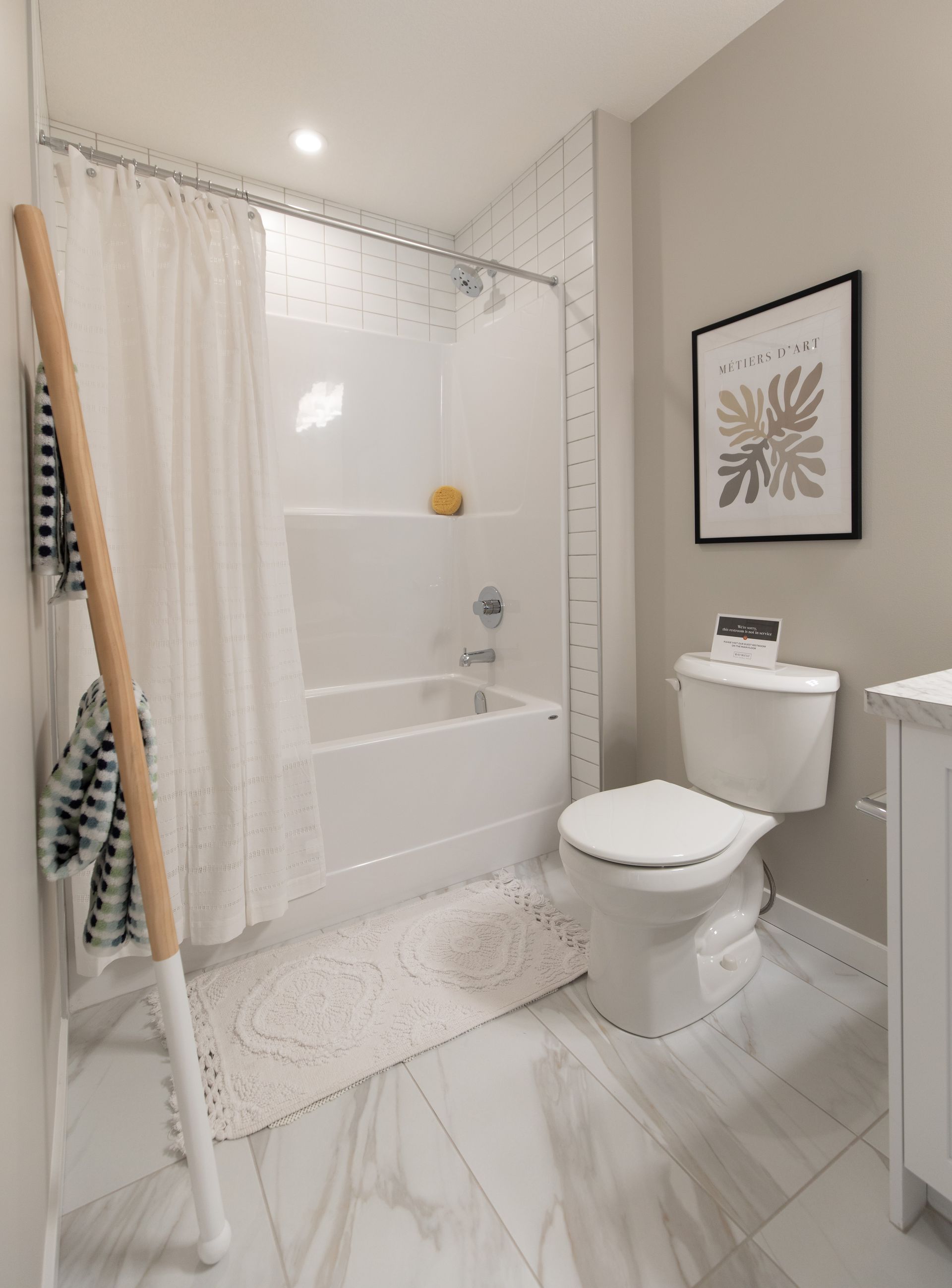 A bathroom with a toilet , bathtub and shower curtain.