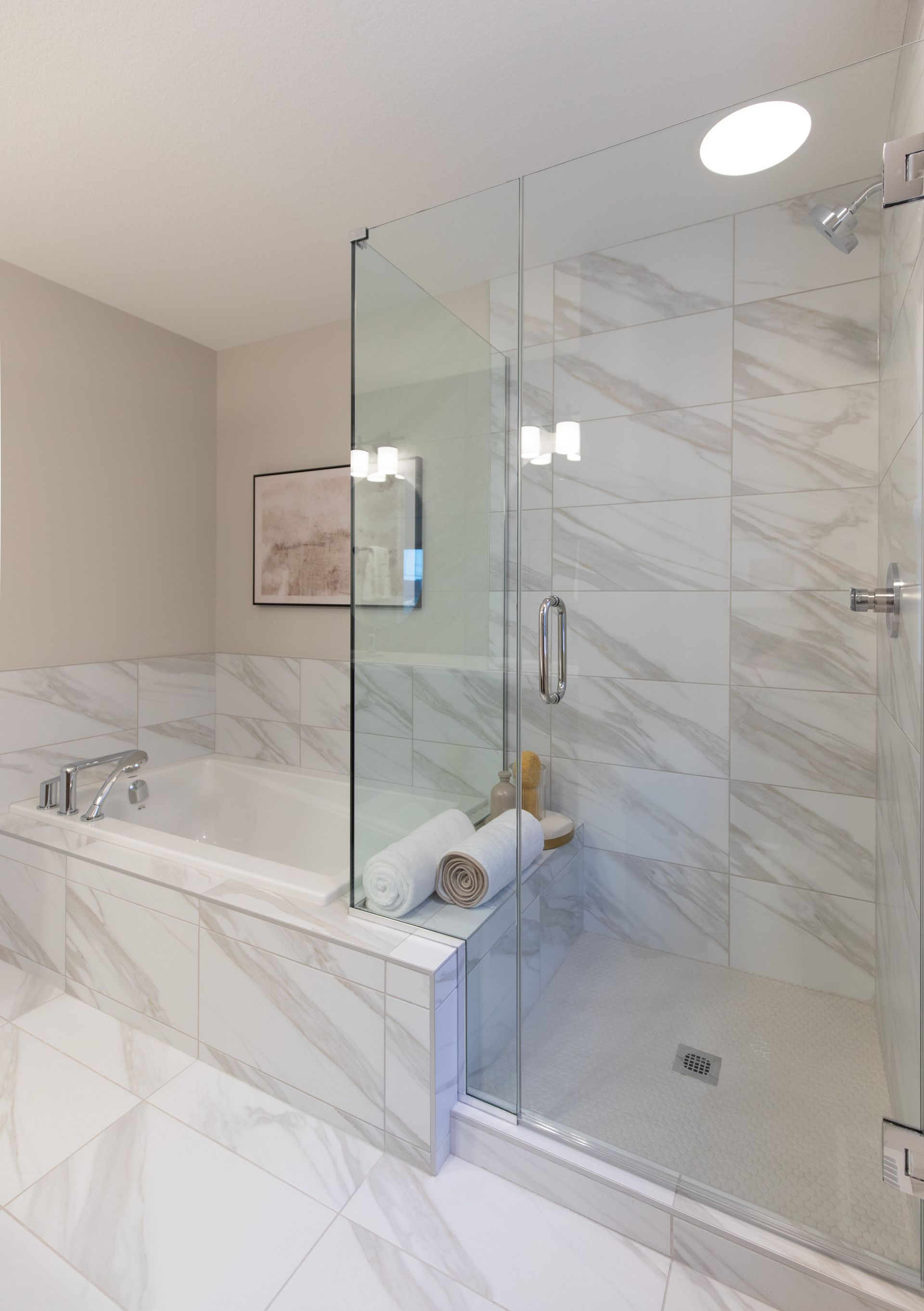 A bathroom with a bathtub and a walk in shower.