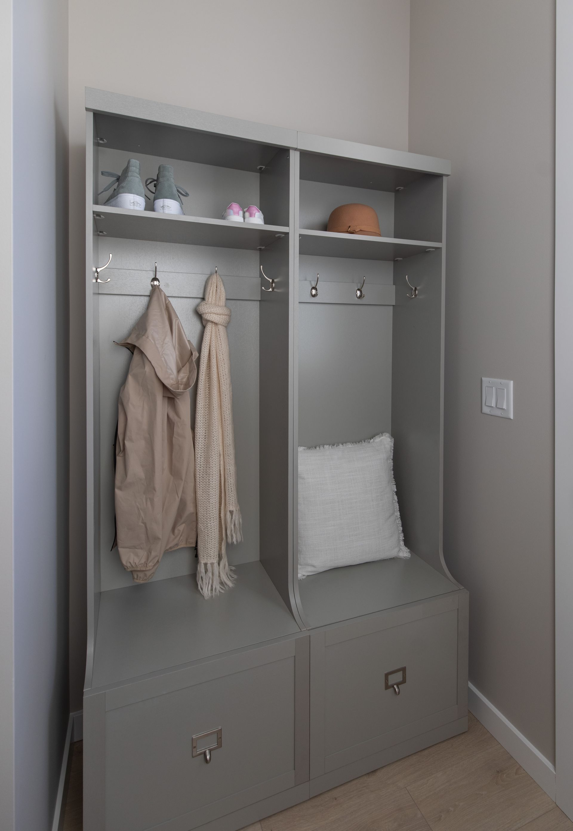 A hallway with a coat rack and a bench.