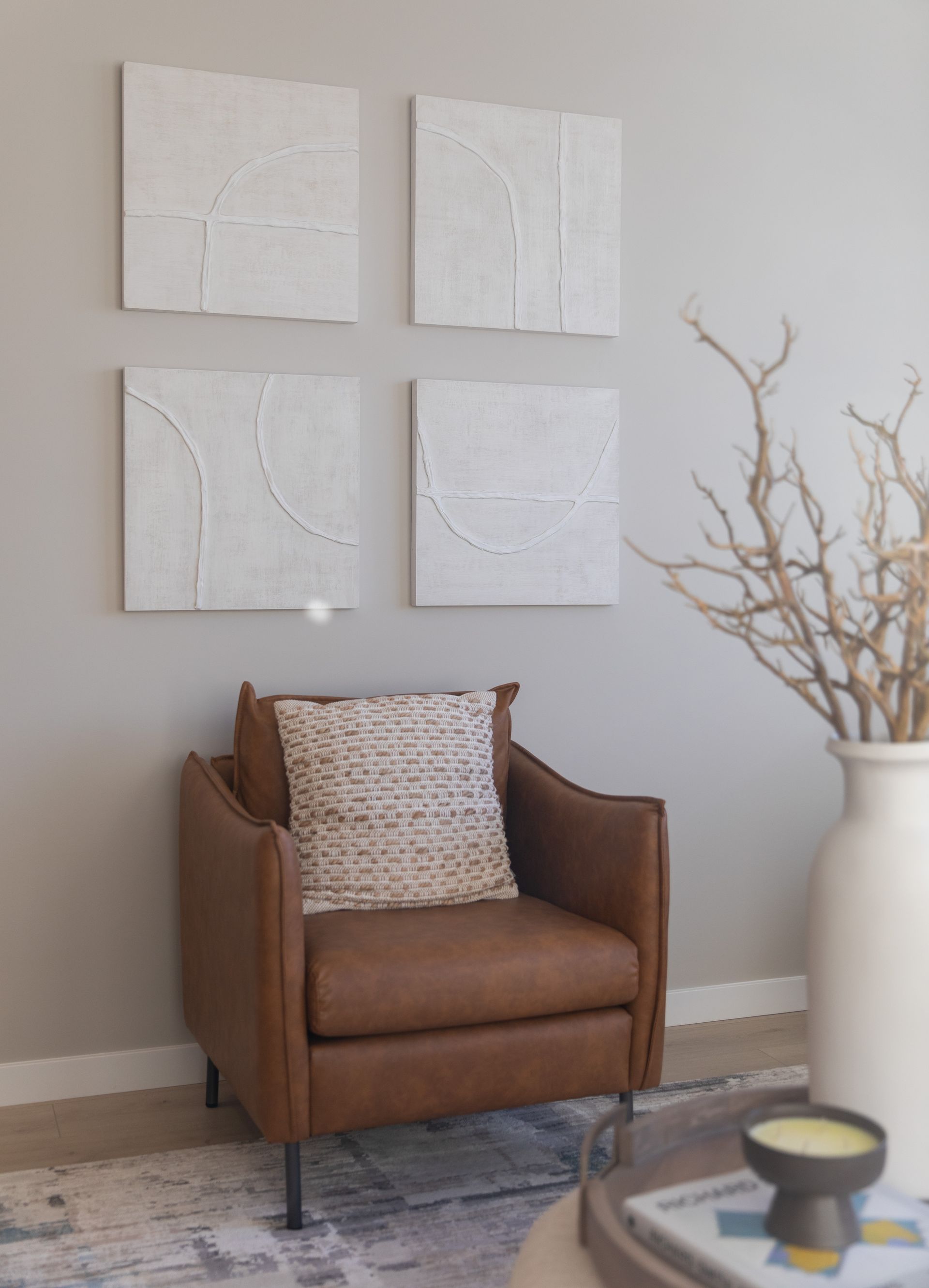 A brown leather chair is sitting in a living room next to a coffee table.
