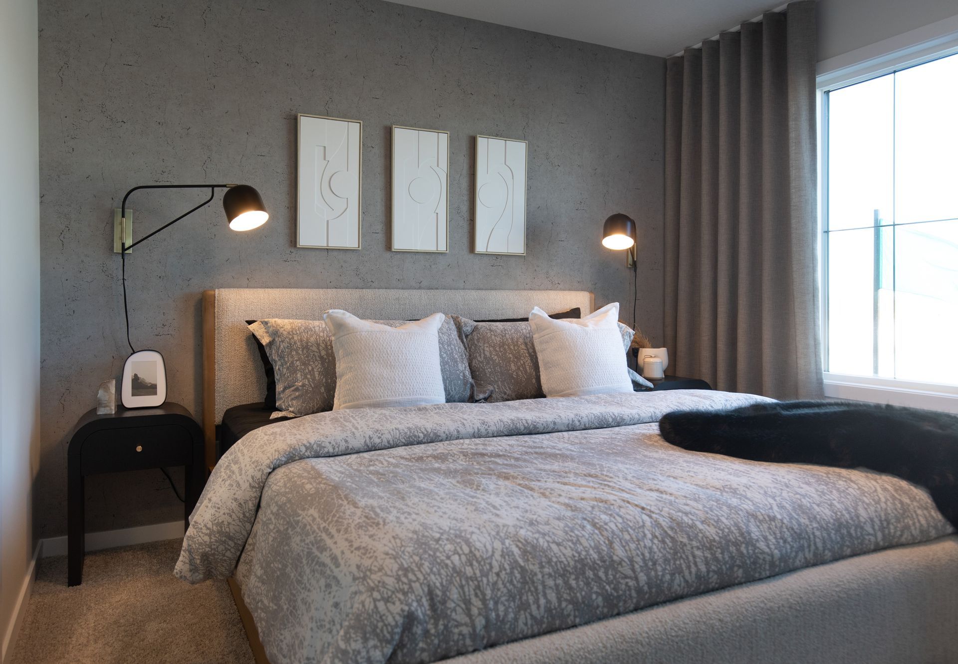 A bedroom with a large bed and a window.