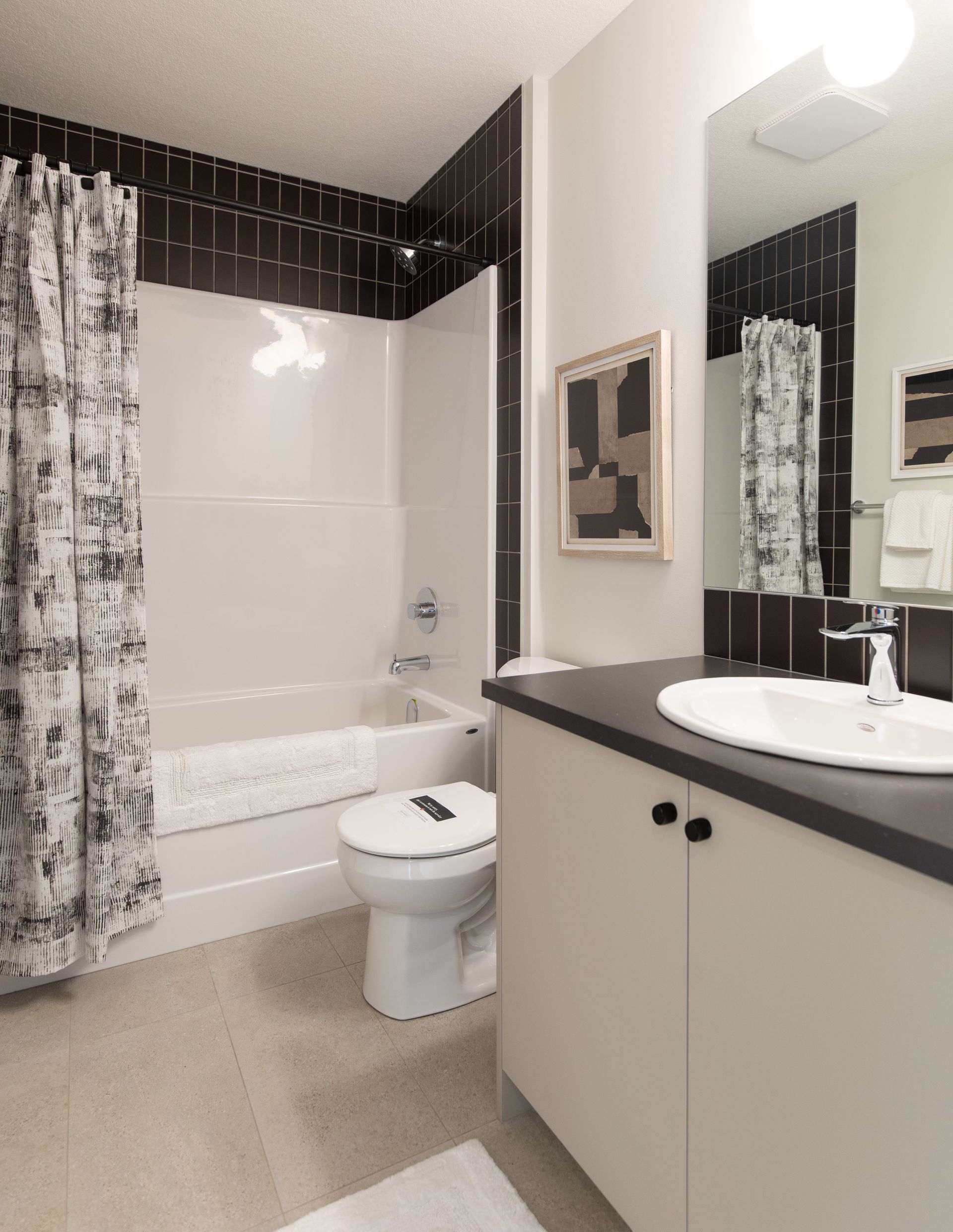 A bathroom with a toilet a sink and a bathtub