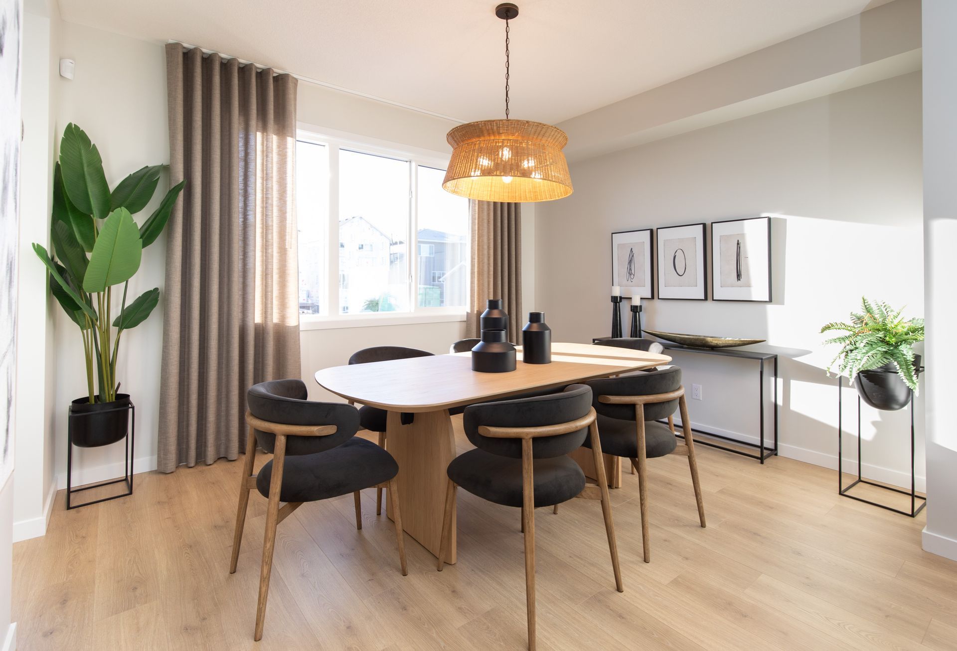 A dining room with a table and chairs and a chandelier.