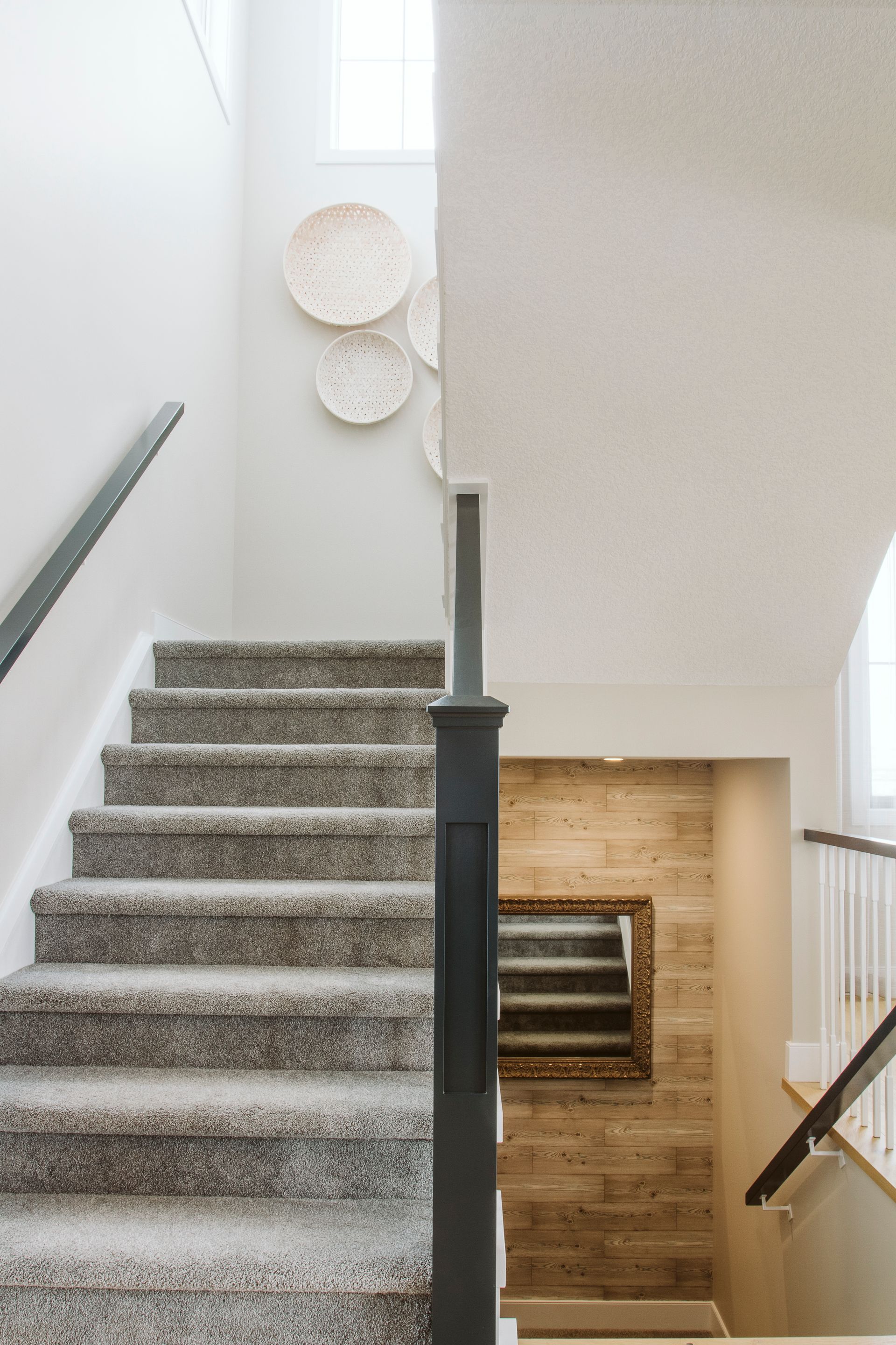 A staircase with carpeted steps leading up to the second floor of a house.